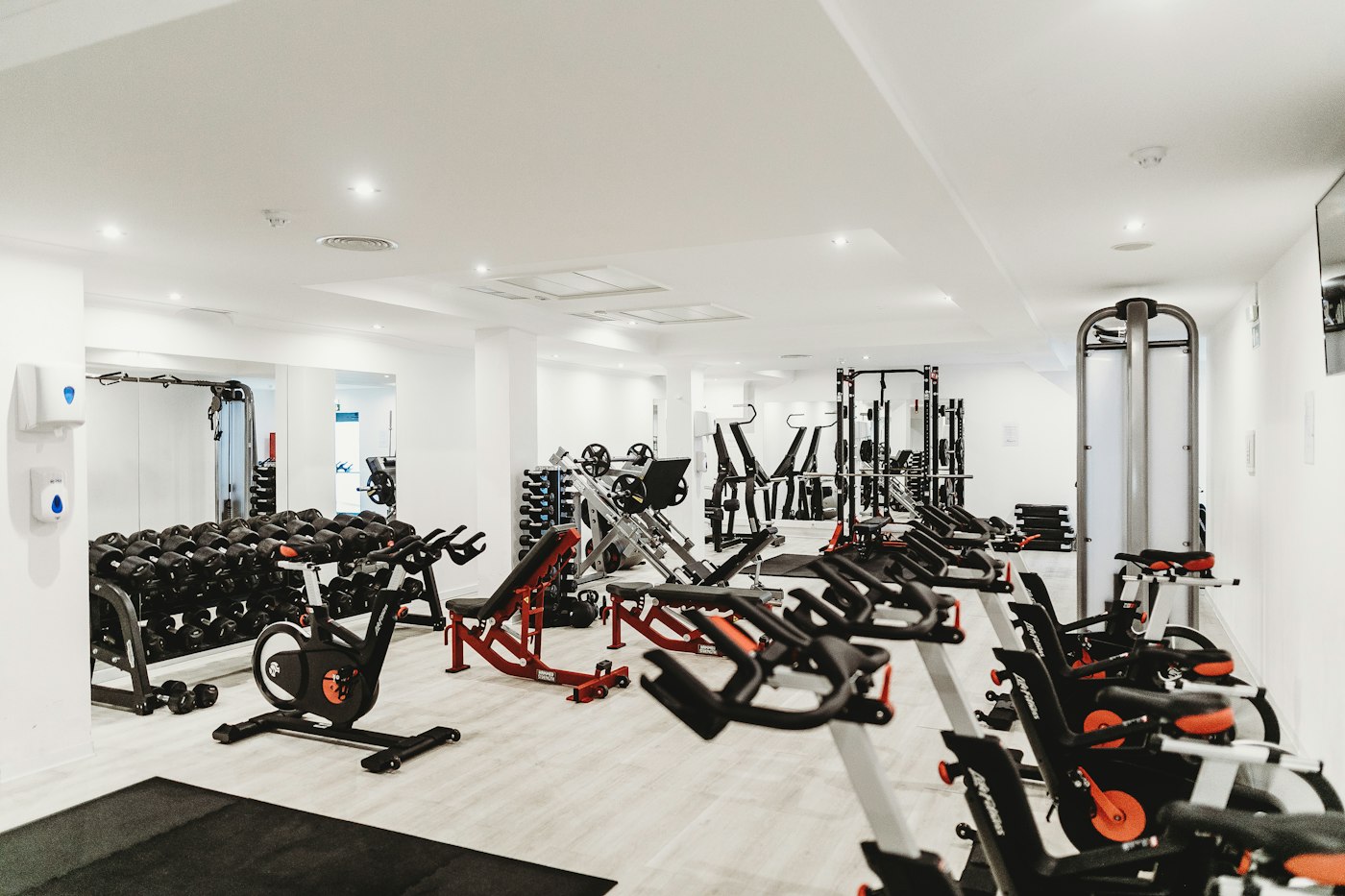 Bright boutique strength studio with racks and open floor