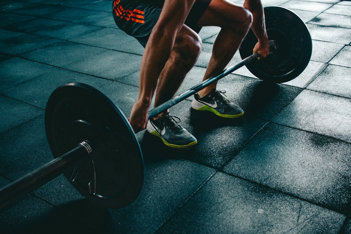 Athlete gripping a loaded barbell for a deadlift